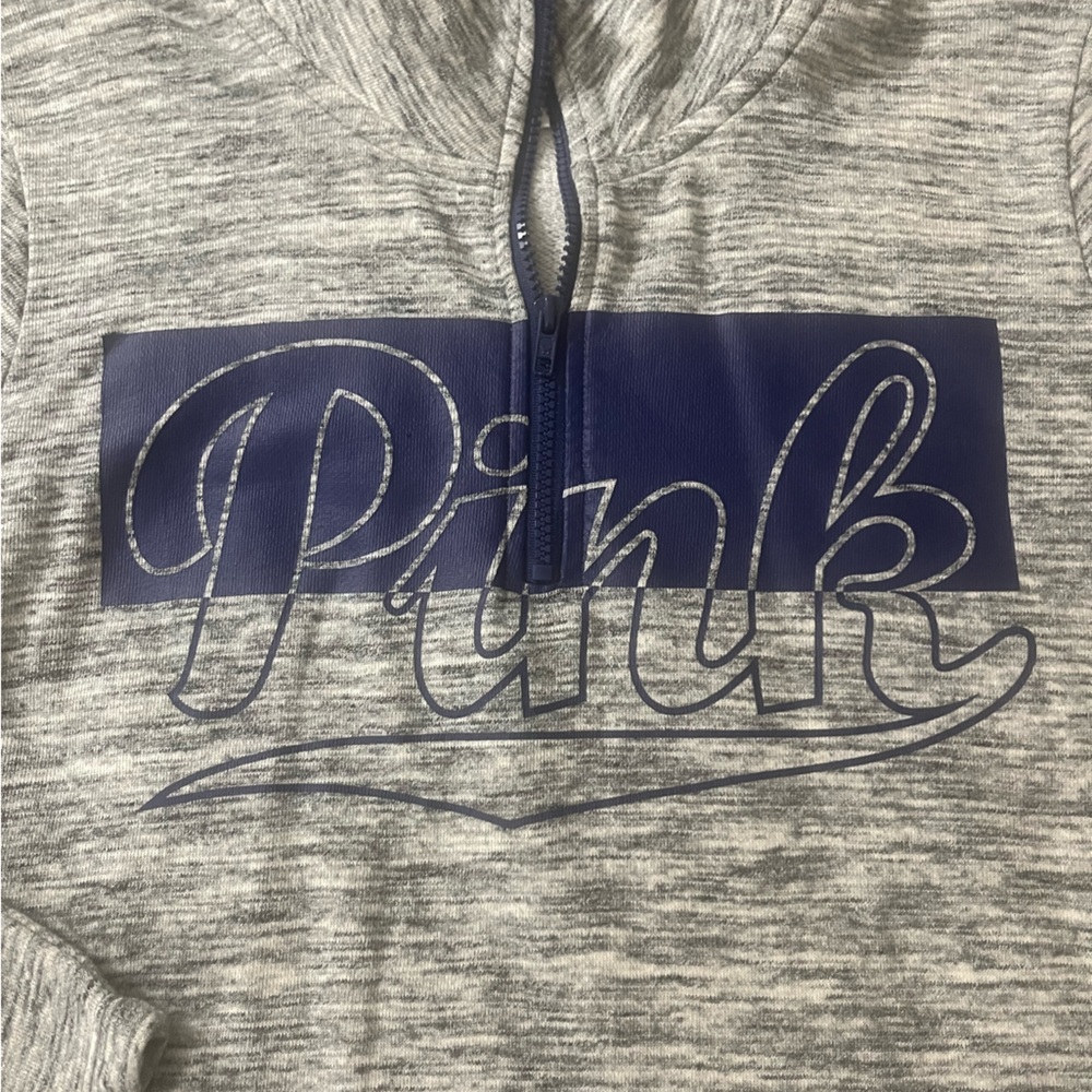 Pink quarter zip pullover, grey and blue in color